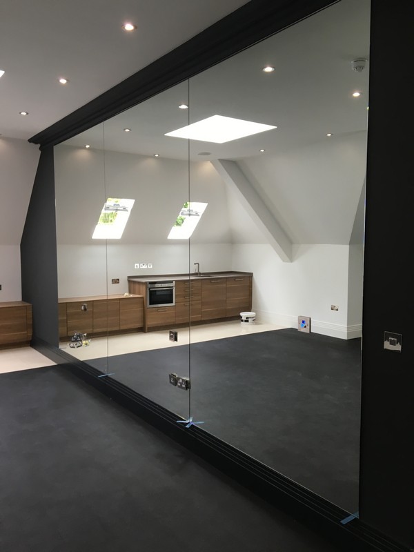 Frameless glass partition in loft conversion by East Dulwich glaziers