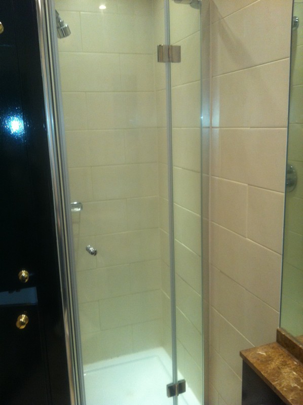 Frameless glass shower enclosure with chrome fittings in East Dulwich