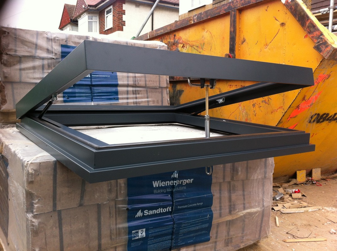 Opening flat roof skylight in anthracite grey installed in East Dulwich