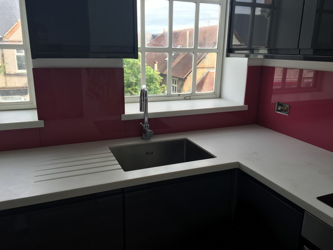Deep plum coloured glass splashback in modern East Dulwich kitchen